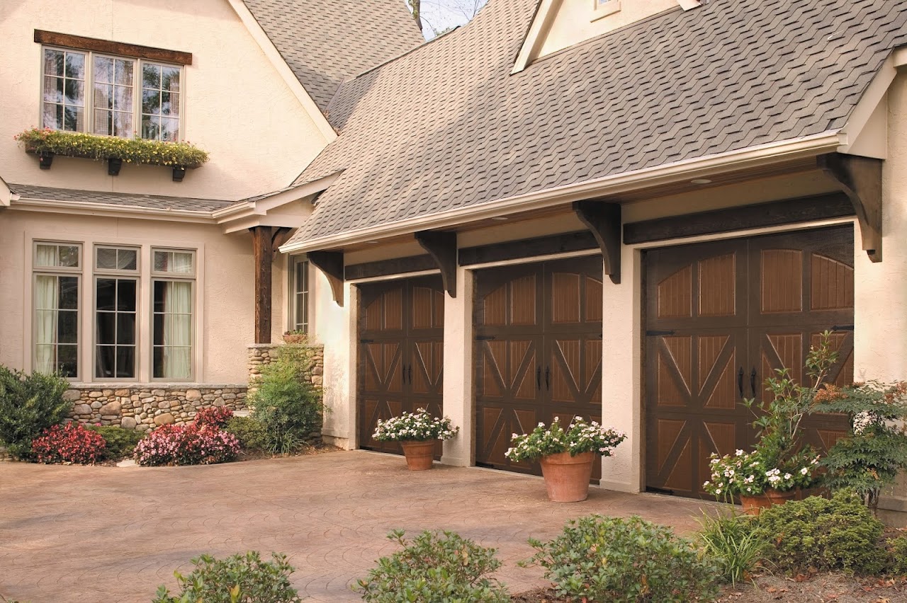 Carriage-style garage doors with X-brace design on a stucco home